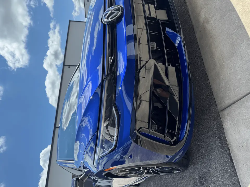 Blue Volkswagen with Geoshield ceramic window tint and glossy finish outside the Texas Automotive Care Solutions shop in Boerne, TX